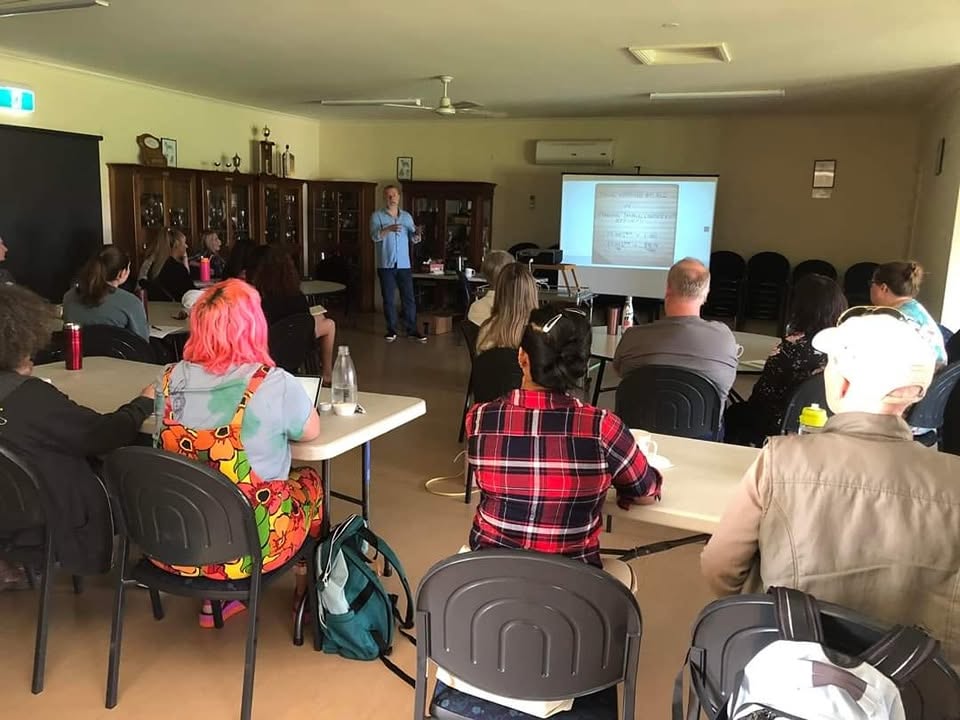 John McGuigan delivering a dog training workshop with a projector presentation